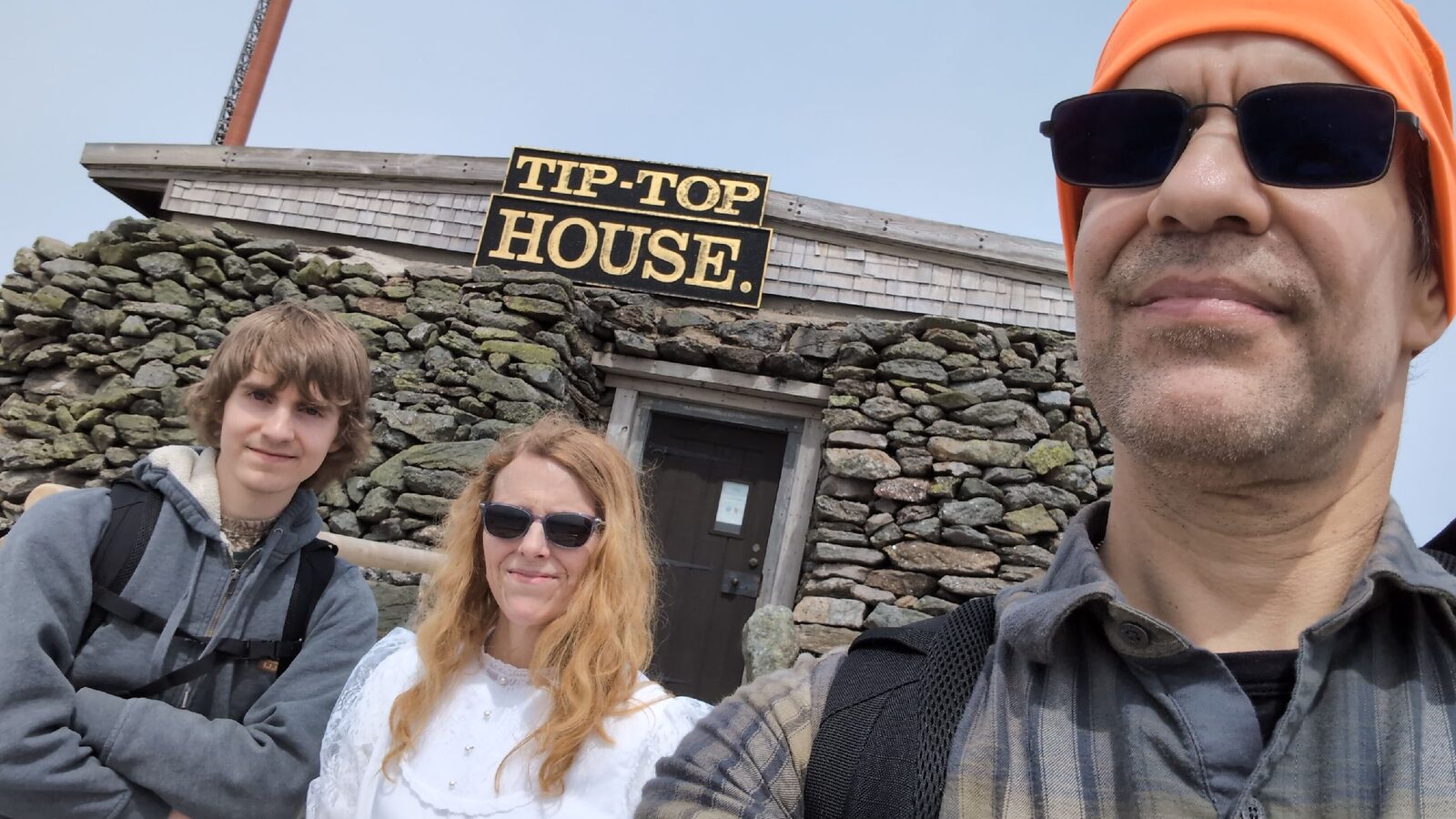 Tip Top House exterior on the Mount Washington summit, stone building with original painted sign